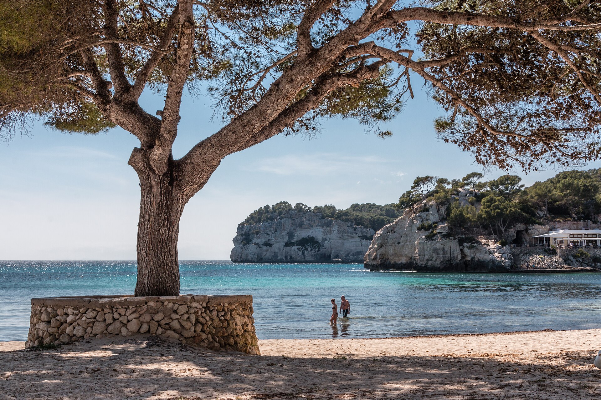 Pale cliffs and turquoise water of Cala Galdana on Menorca's south coast