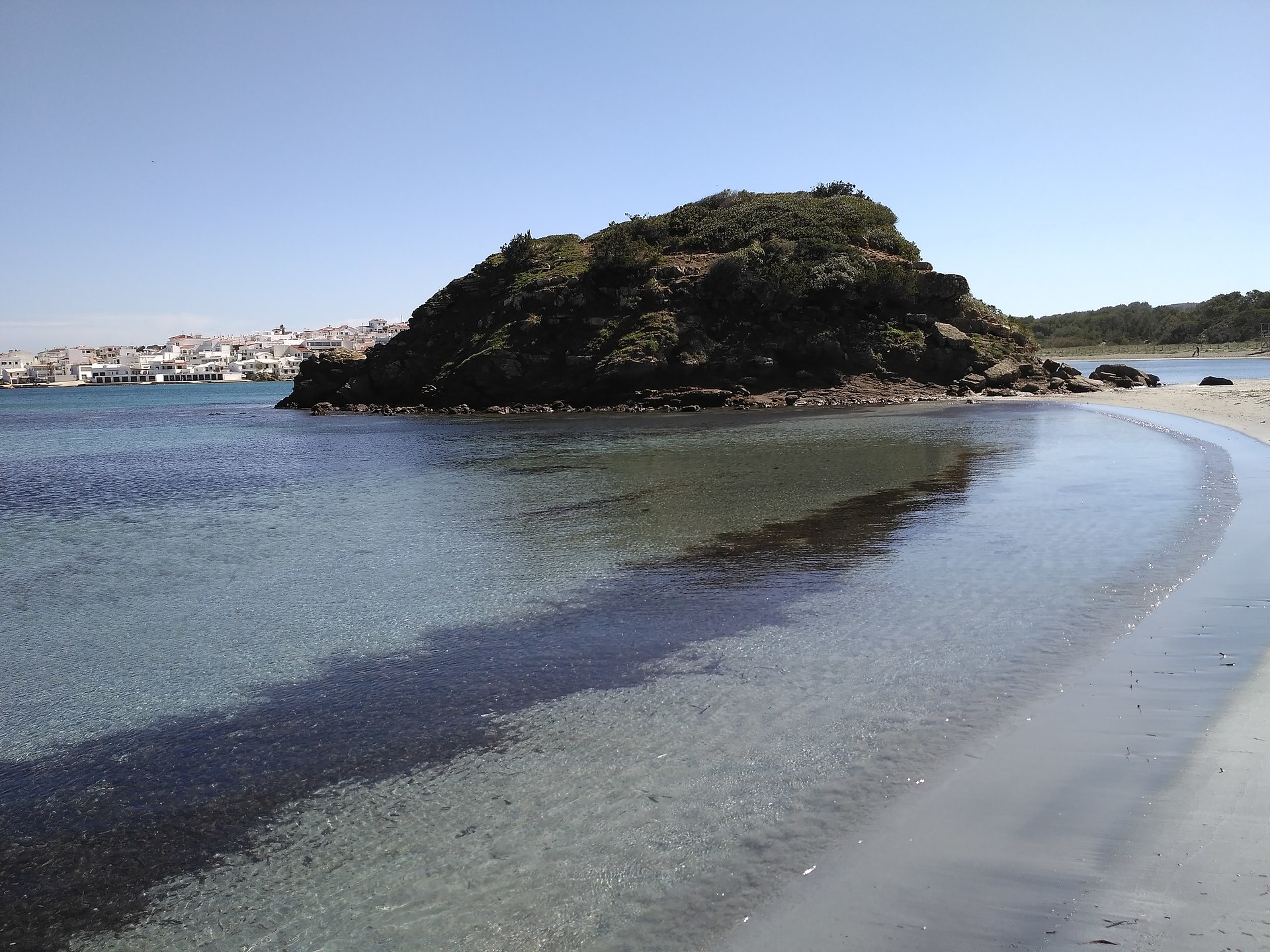 Shallow turquoise bay at Es Grau beside the S'Albufera natural park
