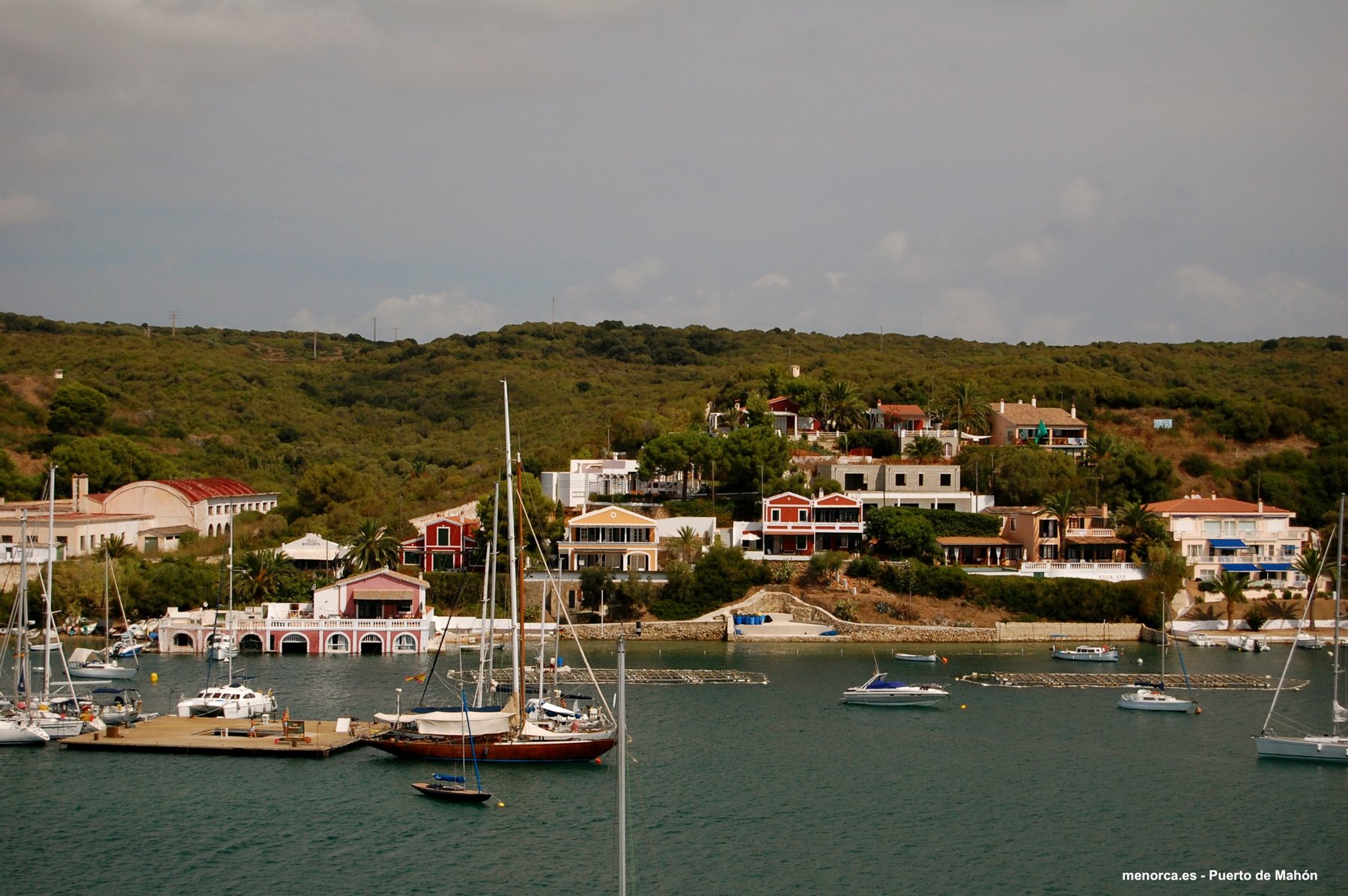 Sailing yachts moored on the water in the natural harbour of Mahón, Menorca