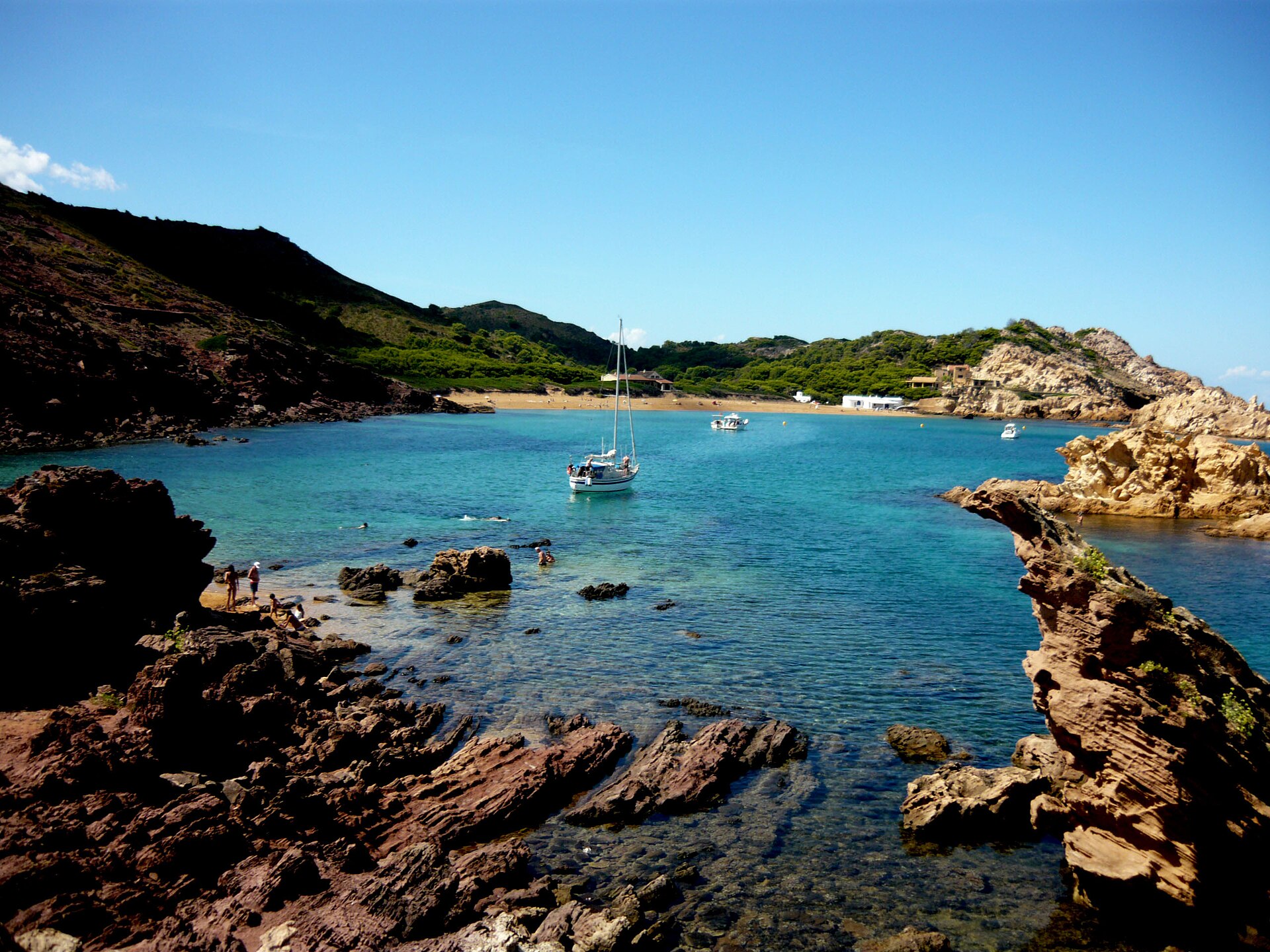 Red-sand beach and offshore islets at Cala Pregonda, north Menorca